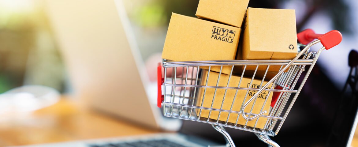 Package boxes in cart with laptop computer for online shopping c